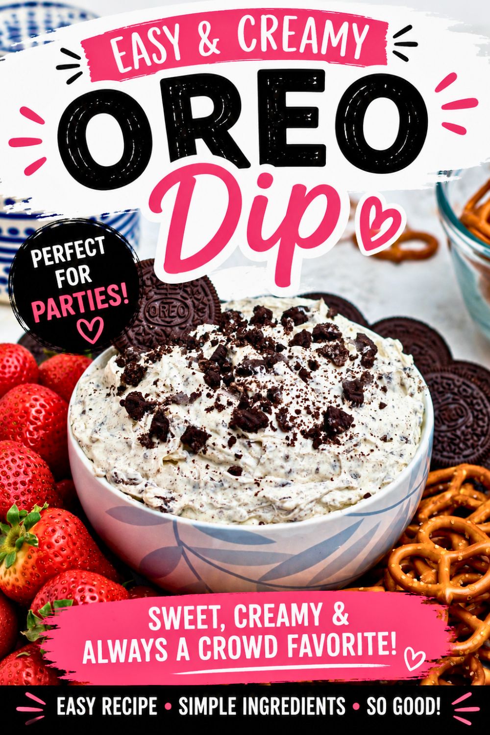 Strawberries, pretzels, and chocolate cookies, on a round white plate, around a cookies and cream Oreo dip, on a marble table.