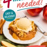 Slice of apple dump cake, topped with a scoop of ice cream, on a small round white plate, with apple slices in front of the plate.