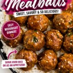 Black plate topped with white rite and juicy meatballs surrounded by chopped onions and sesame seeds on a marble table.