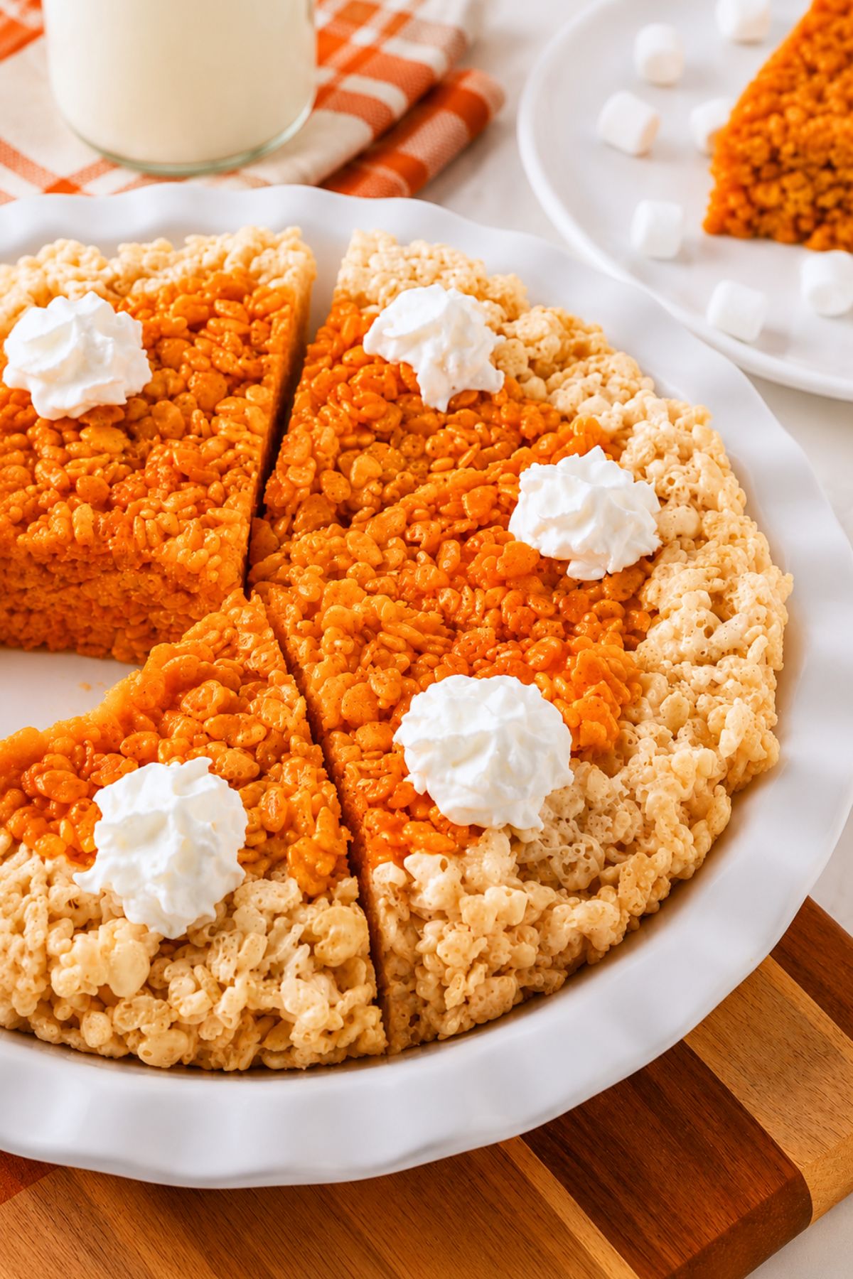 Whole pie of krispie treats in a pie plate, after cutting, on a marble table.