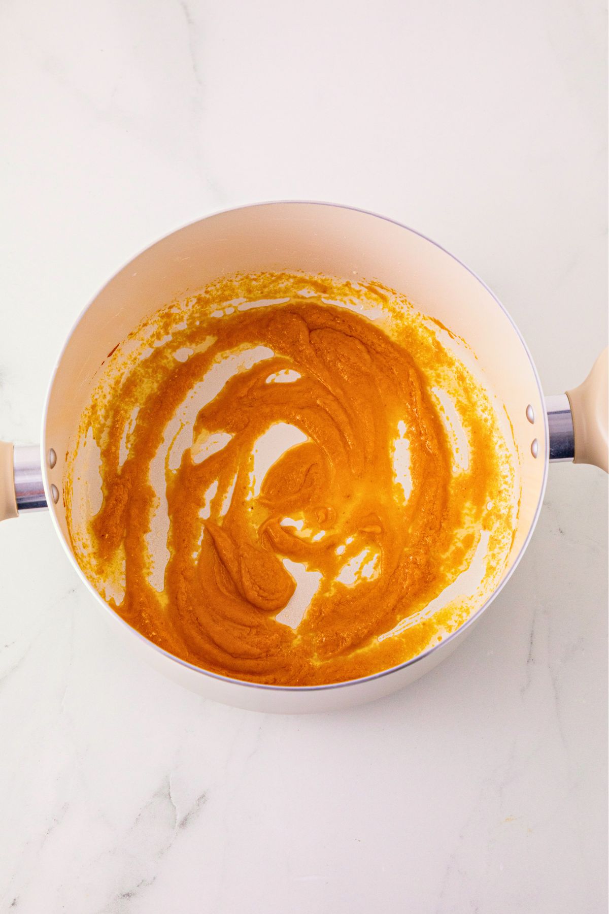 Pumpkin puree stirred into melted butter, in a large saucepan. 