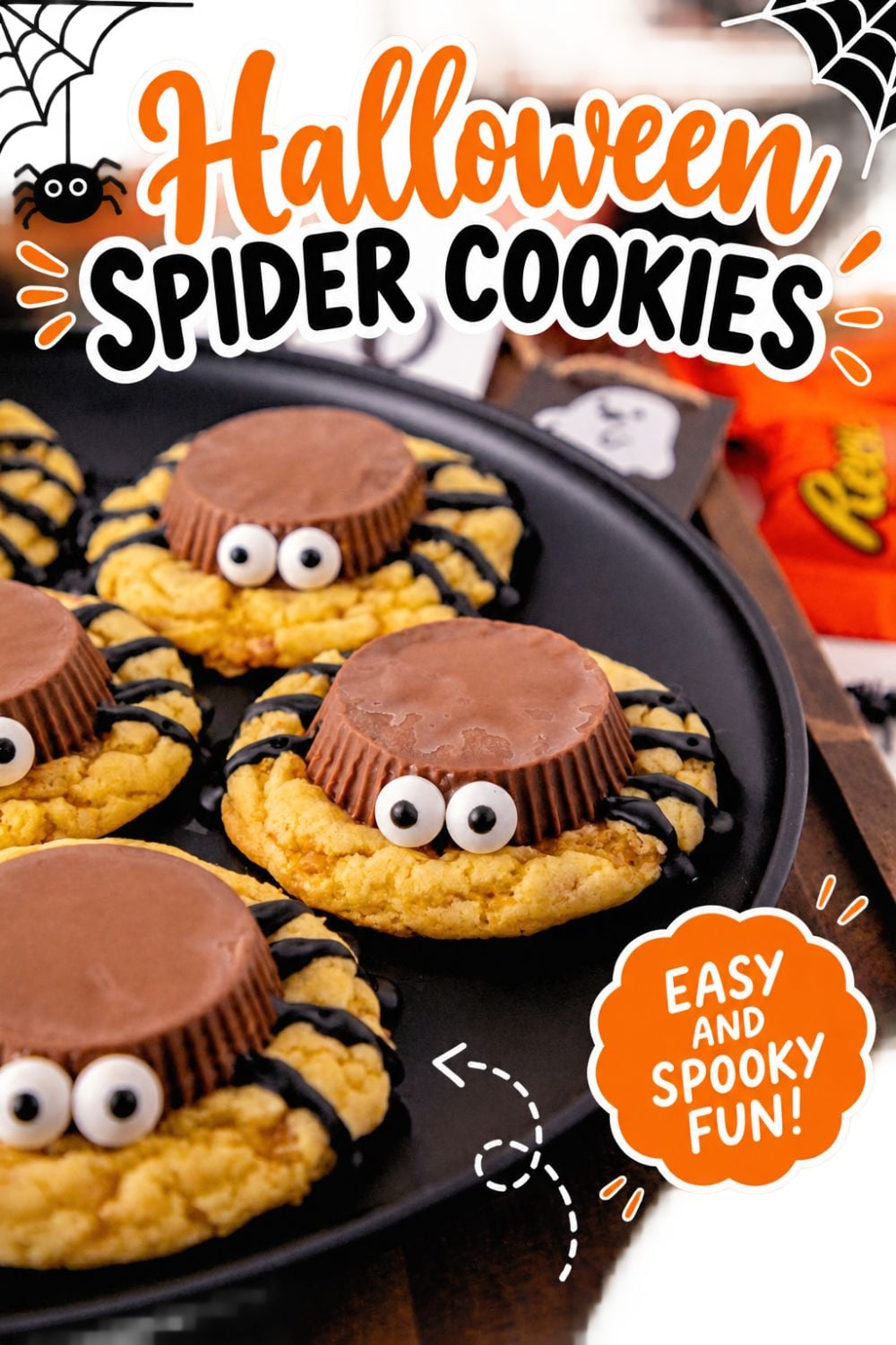 Black plate filled with spider cookies with Halloween decorations on the table.