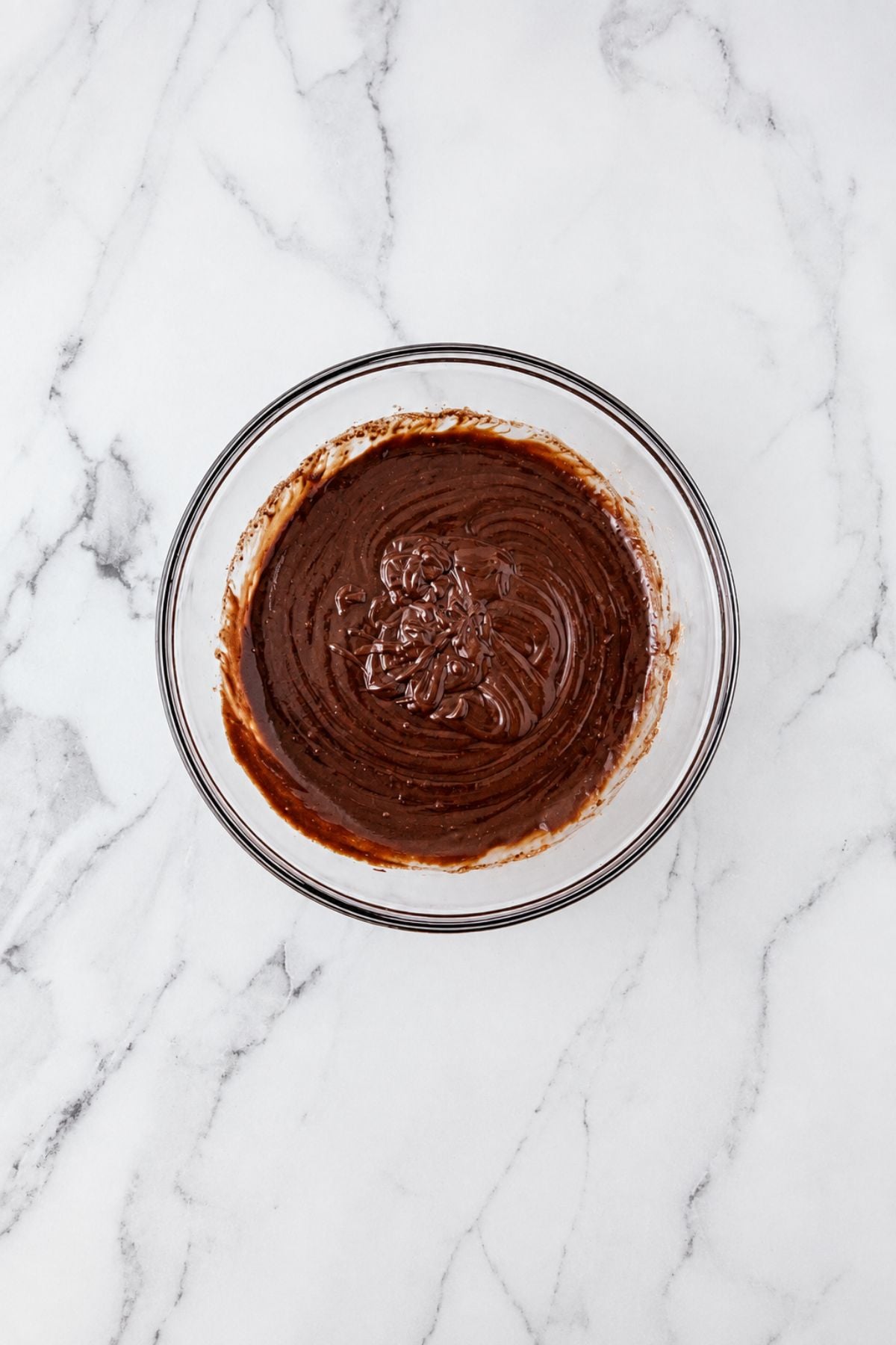 Large bowl filled with brownie mix, after combining oil, egg, and water with mix.